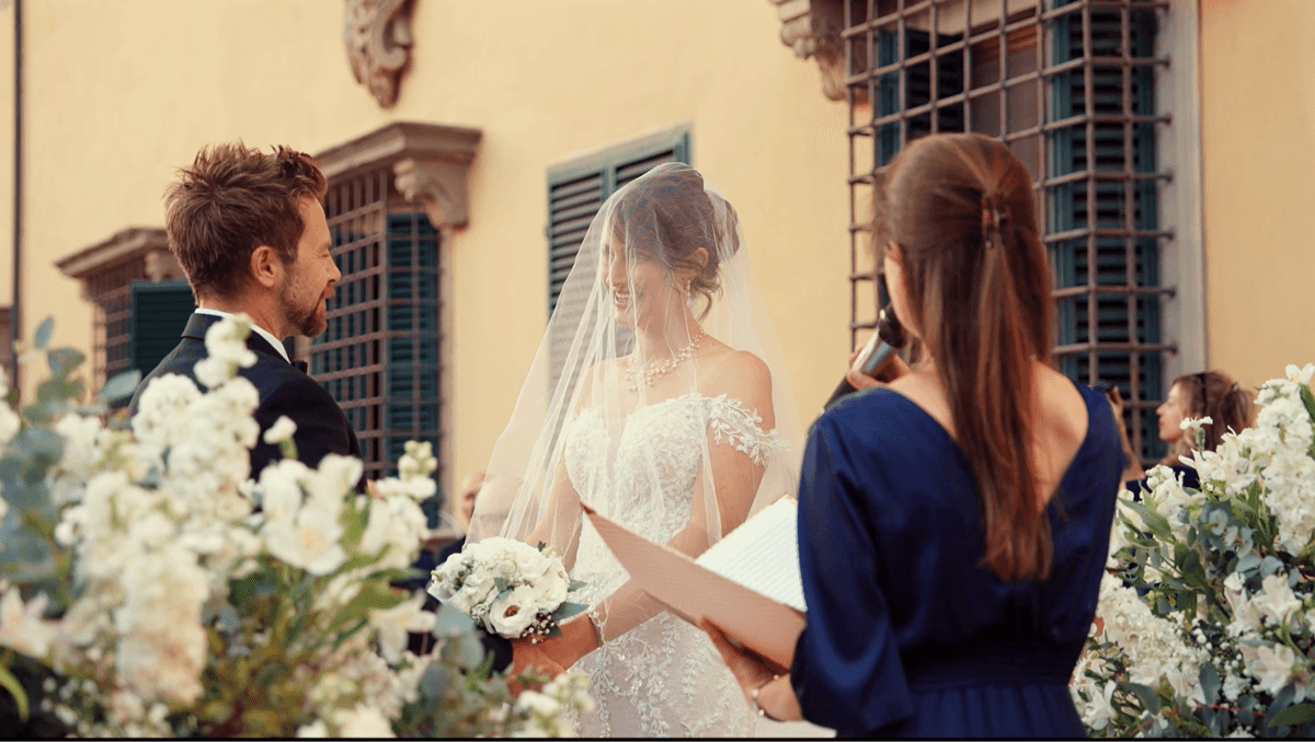 A bride and groom walking in an Italian village.
