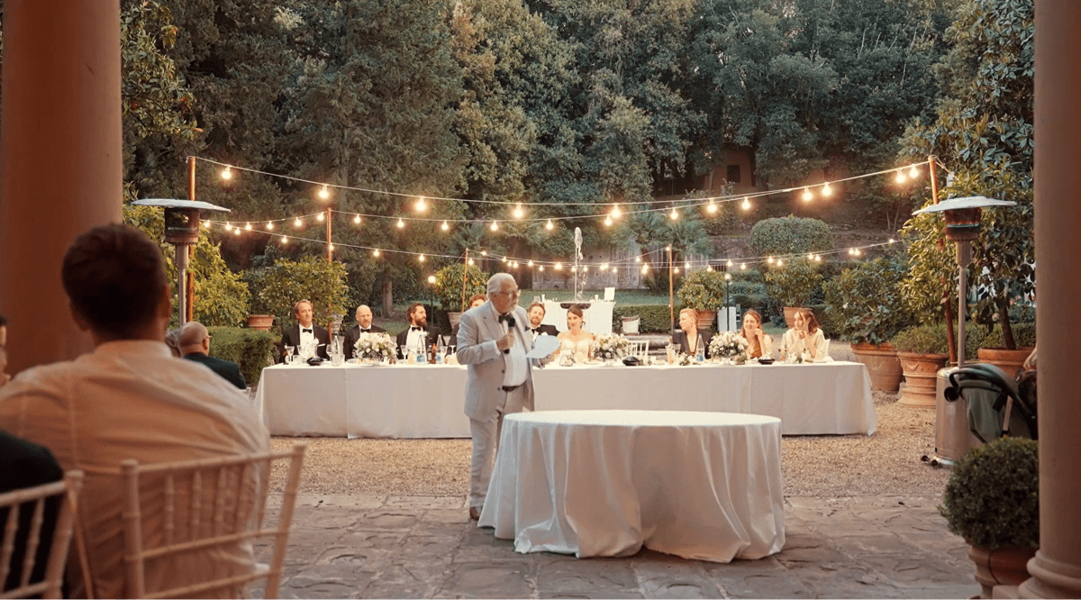 A bride and groom embracing on a balcony in Italy.